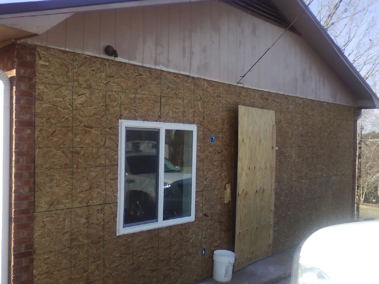 OSB sheathing on a garage addition wall before siding in Glen Rock