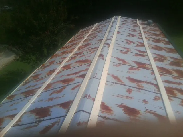 Rusted metal roof panels with new wood purlins before replacement — Storm Damage Roof Repair in Glen Rock by Roofing Brothers