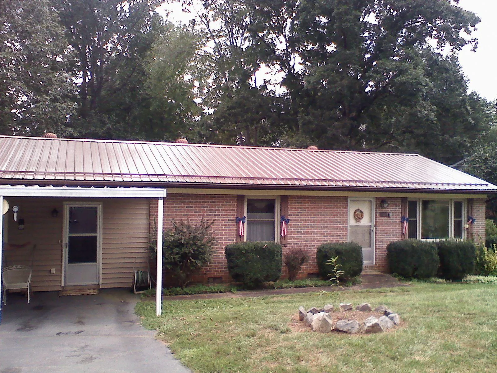 Bronze metal roof and carport on a brick ranch home — Roof Repair work by our crew in Glen Rock